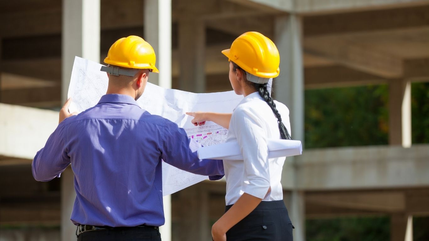 Construction project management team reviewing plans on a California project
