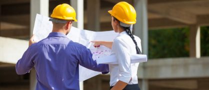 Construction project management team reviewing plans on a California project